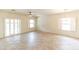 Spacious living room with tiled floors, bright lighting, and plenty of natural light at 25640 N 108Th Dr, Peoria, AZ 85383