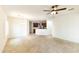 Open-concept living space leading into a modern kitchen and dining area with tiled flooring at 25640 N 108Th Dr, Peoria, AZ 85383