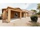 Covered patio with posts is set in spacious backyard with desert landscaping at 25640 N 108Th Dr, Peoria, AZ 85383