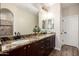 Ensuite bathroom offers dual sinks, granite countertops, and walk-in shower for a spa-like experience at 26391 N 107Th Dr, Peoria, AZ 85383