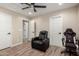 Bedroom boasts recessed lighting, a ceiling fan and two black leather gaming chairs, perfect for a gaming enthusiast at 26391 N 107Th Dr, Peoria, AZ 85383