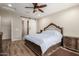 Well-appointed bedroom showcases a sliding barn door to the bath, ceiling fan and ample space at 26391 N 107Th Dr, Peoria, AZ 85383