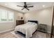 Inviting bedroom features a ceiling fan, wood-look floors and a large window with plantation shutters at 26391 N 107Th Dr, Peoria, AZ 85383