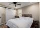 Inviting bedroom features a wood-look floor, a barn door, and a window with plantation shutters at 26391 N 107Th Dr, Peoria, AZ 85383
