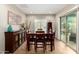 Dining area with neutral walls, tile floors, and sliding door access to the backyard at 26391 N 107Th Dr, Peoria, AZ 85383