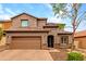 Charming two-story home with a well-manicured front yard, a two car garage, and tile roof at 26391 N 107Th Dr, Peoria, AZ 85383