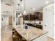 Spacious kitchen featuring granite counters, stainless appliances, and stylish pendant lighting over a large island at 26391 N 107Th Dr, Peoria, AZ 85383