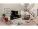 Open concept living room with staircase, large sectional, and tall ceilings at 26391 N 107Th Dr, Peoria, AZ 85383