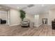 Upstairs loft with wood-look floors, an accent chair, and views of downstairs at 26391 N 107Th Dr, Peoria, AZ 85383