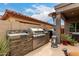 Outdoor kitchen with grill, cooktop and counterspace, ideal for entertaining and alfresco dining at 26391 N 107Th Dr, Peoria, AZ 85383