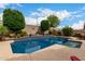 Gorgeous pool with a rock waterfall feature, mature landscaping, and spacious surrounding area, perfect for outdoor enjoyment at 26391 N 107Th Dr, Peoria, AZ 85383