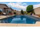 Backyard oasis with a sparkling pool, cozy lounge area, and privacy landscaping, creating a perfect retreat at 26391 N 107Th Dr, Peoria, AZ 85383