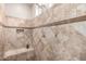 Walk-in shower with decorative tile, bench, and niche offers a luxurious bathing experience at 26391 N 107Th Dr, Peoria, AZ 85383