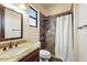 Well-lit bathroom includes a granite vanity, toilet, and a shower with decorative tile and curtain at 28025 N 156Th Pl, Scottsdale, AZ 85262