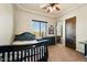 Comfortable bedroom with dark furniture, window view, and wood door to an ensuite bathroom at 28025 N 156Th Pl, Scottsdale, AZ 85262