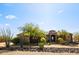 Exterior view of home with desert landscaping, mature trees, and stone accents at 28025 N 156Th Pl, Scottsdale, AZ 85262