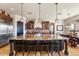 Spacious kitchen featuring a large granite island with pendant lighting and dark wood cabinets at 28025 N 156Th Pl, Scottsdale, AZ 85262