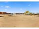 Spacious lot showcasing expansive land and multiple residential structures in the distance at 28025 N 156Th Pl, Scottsdale, AZ 85262
