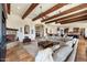 Open concept living room featuring a fireplace, exposed wood beams, and tile flooring at 28025 N 156Th Pl, Scottsdale, AZ 85262