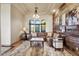 Cozy living room features wood accent wall, neutral colored sofa, and tray ceilings at 28025 N 156Th Pl, Scottsdale, AZ 85262