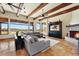 Spacious living room features exposed wood beam ceiling, stone fireplace, and view at 28025 N 156Th Pl, Scottsdale, AZ 85262