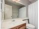 Neutral-toned bathroom featuring a large mirror, spacious vanity, and shower with curtain at 2929 E Broadway Rd # 30, Mesa, AZ 85204