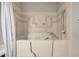 Walk-in bathtub featuring chrome grab bars and ornate tilework at 2929 E Broadway Rd # 30, Mesa, AZ 85204