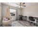 Bedroom with ceiling fan, wood floors, a hanging chair, and office furniture and decor at 2929 E Broadway Rd # 30, Mesa, AZ 85204