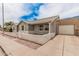Home featuring a decorative brick wall, a garage, and mature landscaping at 2929 E Broadway Rd # 30, Mesa, AZ 85204