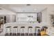 Bright kitchen featuring a breakfast bar, white cabinetry, stainless steel appliances, and tile backsplash at 2929 E Broadway Rd # 30, Mesa, AZ 85204