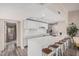 Bright kitchen with white cabinets, breakfast bar, and stainless steel appliances overlooking living spaces at 2929 E Broadway Rd # 30, Mesa, AZ 85204
