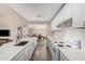 Open kitchen featuring an island with sink, white appliances, and lots of cabinets at 2929 E Broadway Rd # 30, Mesa, AZ 85204