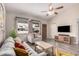 Spacious living room with a large windows, a fan, and modern furnishings at 2929 E Broadway Rd # 30, Mesa, AZ 85204