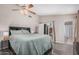 Primary bedroom featuring a ceiling fan, vinyl plank flooring, and backyard access at 2929 E Broadway Rd # 30, Mesa, AZ 85204