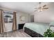 Main bedroom with a ceiling fan, window with curtains, and vinyl plank flooring at 2929 E Broadway Rd # 30, Mesa, AZ 85204