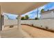 Large covered patio and backyard featuring a desert landscape and white block fence at 3315 E Taro Ln, Phoenix, AZ 85050