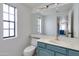 Bathroom featuring a vanity with a vessel sink, large mirror, and a window for natural light at 3315 E Taro Ln, Phoenix, AZ 85050