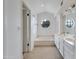 Bright bathroom featuring a double sink vanity and a soaking tub under a round window at 3315 E Taro Ln, Phoenix, AZ 85050