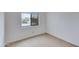 Empty bedroom featuring a window and neutral carpet at 3315 E Taro Ln, Phoenix, AZ 85050