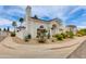 An exterior view of a bright white home with desert landscaping, and mature palm trees at 3315 E Taro Ln, Phoenix, AZ 85050