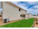 Back of a two-story stucco house with a covered patio and a green lawn at 3315 E Taro Ln, Phoenix, AZ 85050