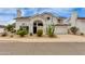 Charming home featuring an arched entryway, desert landscaping, and attached two car garage at 3315 E Taro Ln, Phoenix, AZ 85050