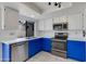 This updated kitchen features stainless steel appliances, white cabinets, and ample counter space at 3315 E Taro Ln, Phoenix, AZ 85050