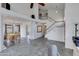 Bright living room featuring tile flooring, large windows, and a staircase to the upper level at 3315 E Taro Ln, Phoenix, AZ 85050