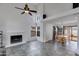Spacious living room with tile flooring, fireplace, and combined dining area with bright windows at 3315 E Taro Ln, Phoenix, AZ 85050