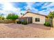 View of the backyard featuring desert landscaping and a screened in porch providing outdoor living space at 3443 E Wickieup Ln, Phoenix, AZ 85050
