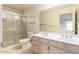 Bathroom featuring a double sink vanity and a glass enclosed shower stall at 3443 E Wickieup Ln, Phoenix, AZ 85050