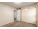 Bedroom with neutral walls and carpet, featuring a window and closet with sliding doors at 3443 E Wickieup Ln, Phoenix, AZ 85050