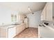 Cozy kitchen with ample counter space, white appliances, and tile flooring at 3443 E Wickieup Ln, Phoenix, AZ 85050