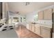 Open kitchen with tile flooring connects to a bright dining area with bay windows, white appliances, and lots of counter space at 3443 E Wickieup Ln, Phoenix, AZ 85050